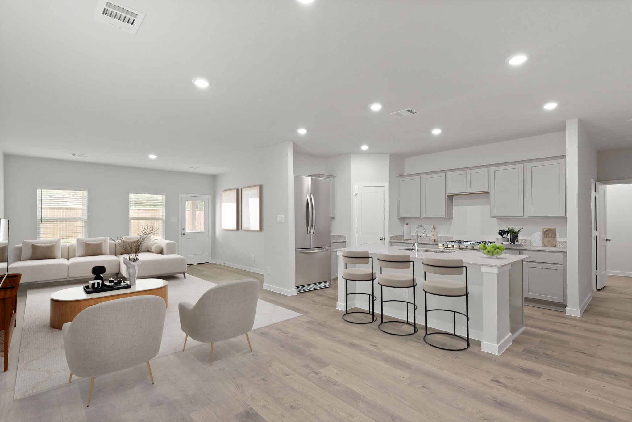 A large living room with a dining table and chairs.