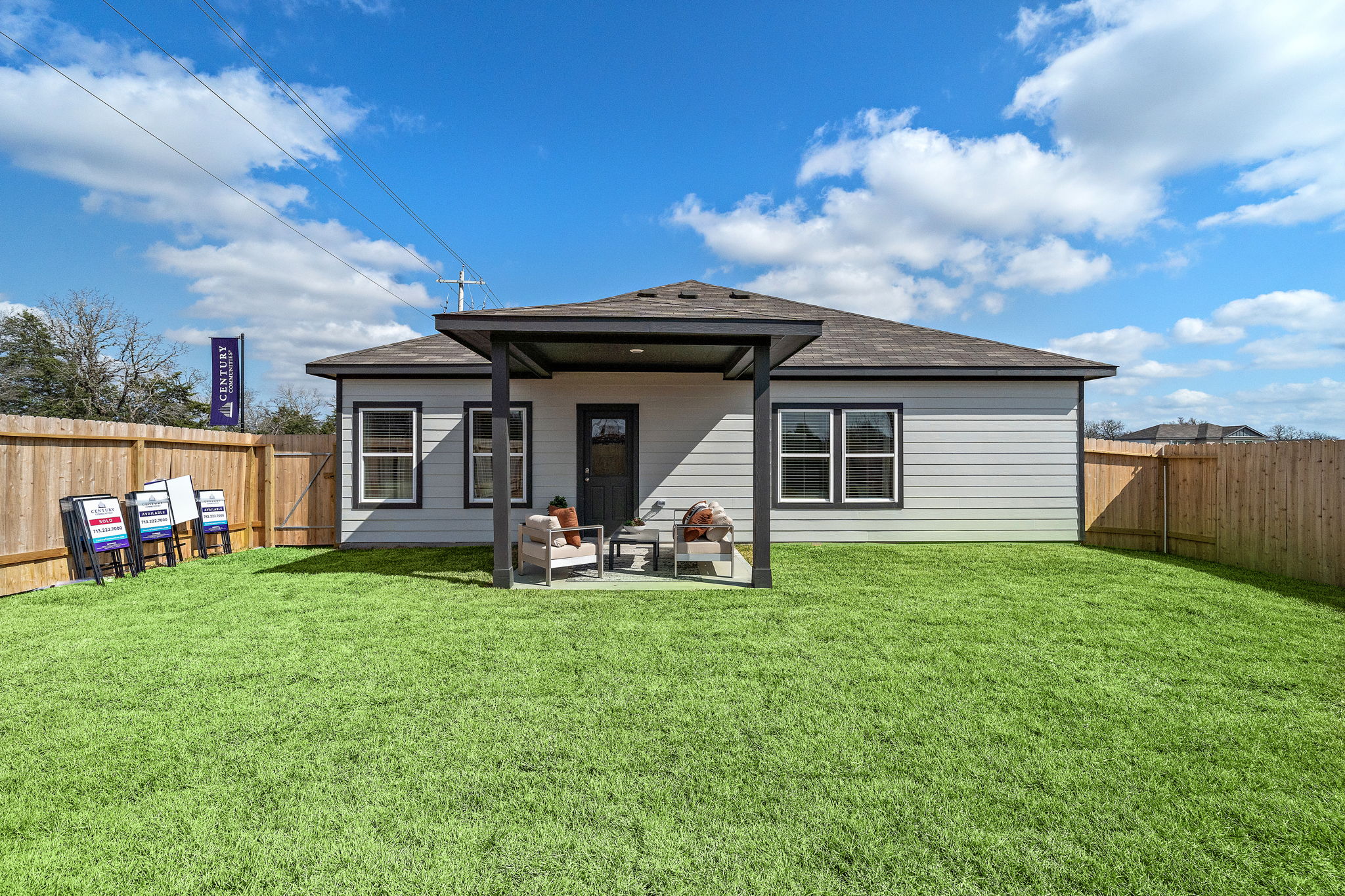 A person sitting in a chair outside a house.
