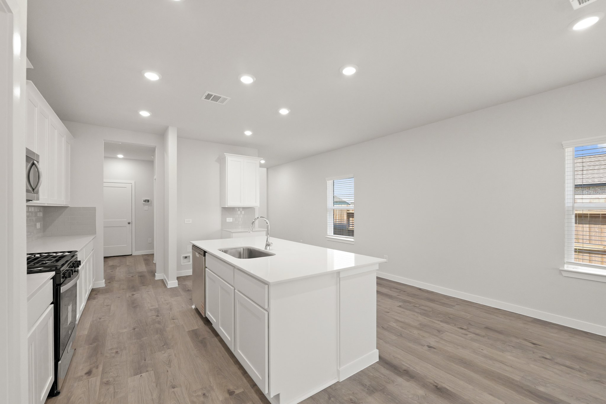 A kitchen with white cabinets.