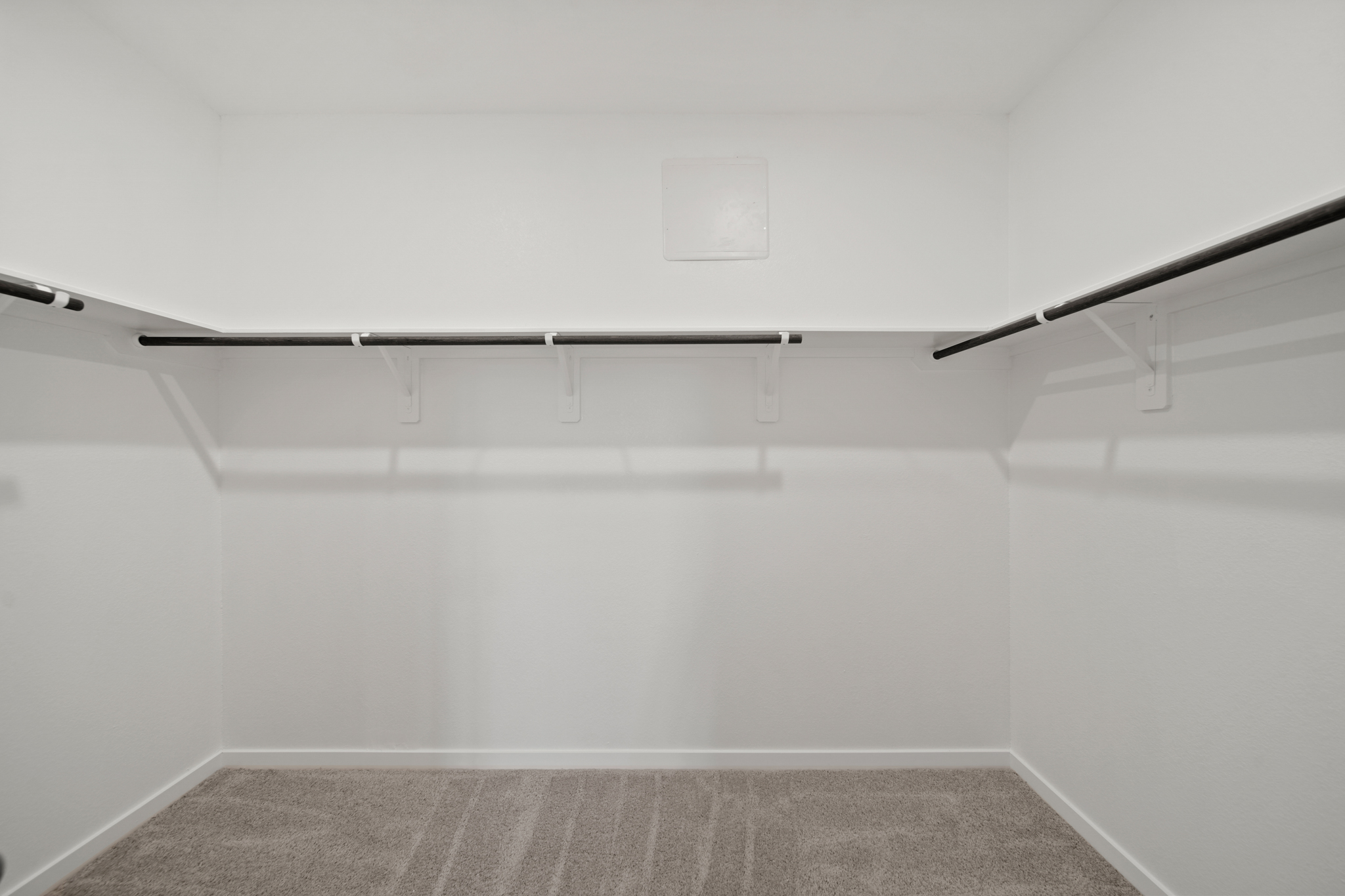 A white wall with a grey floor.