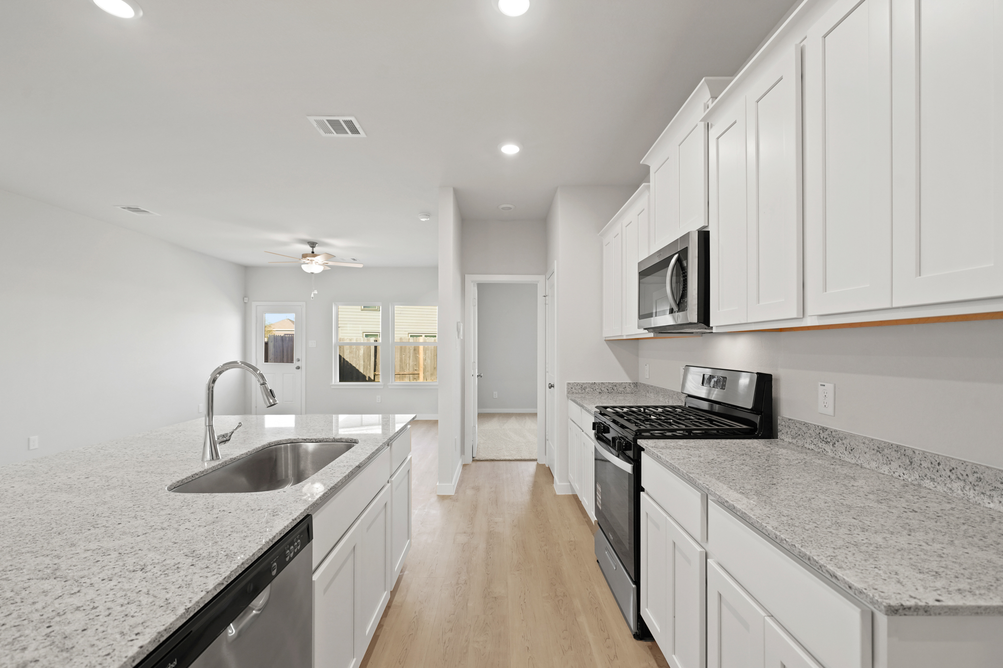 A kitchen with white cabinets.