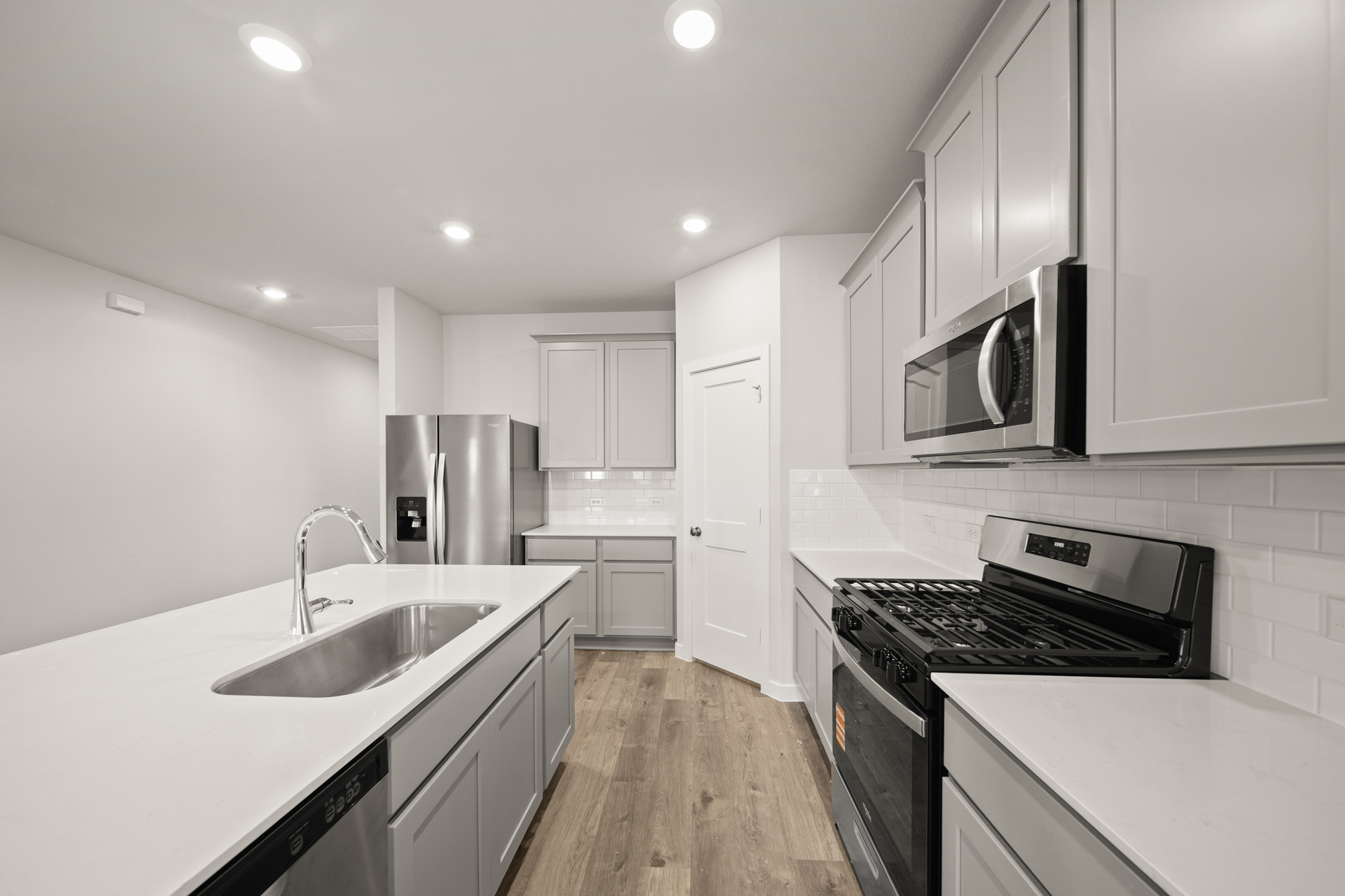 A kitchen with white cabinets.