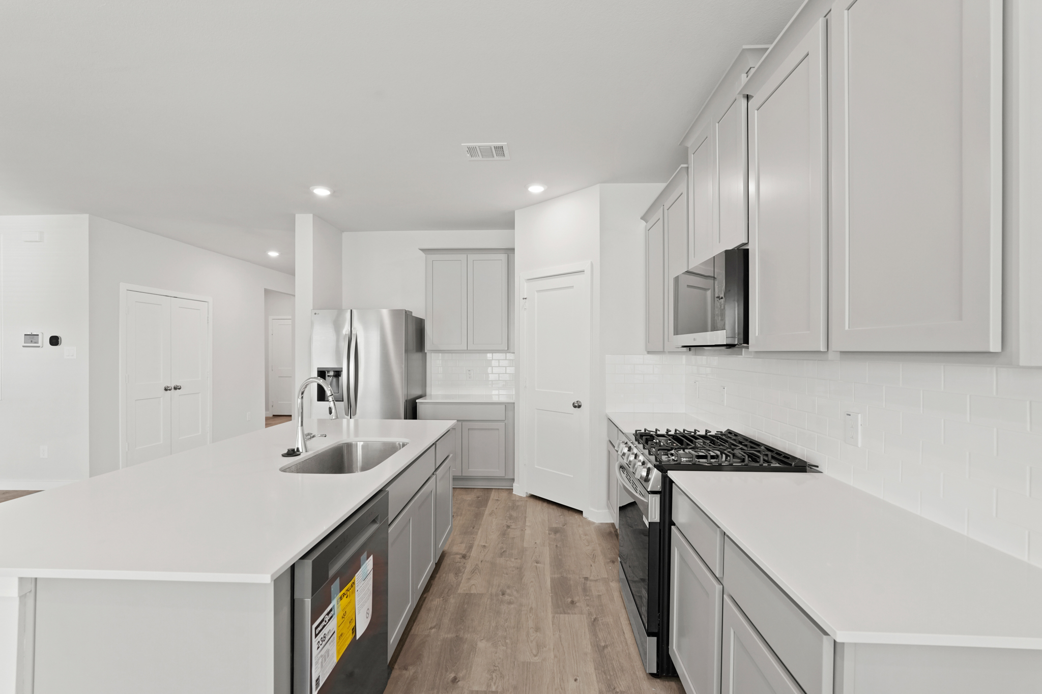 A kitchen with white cabinets.