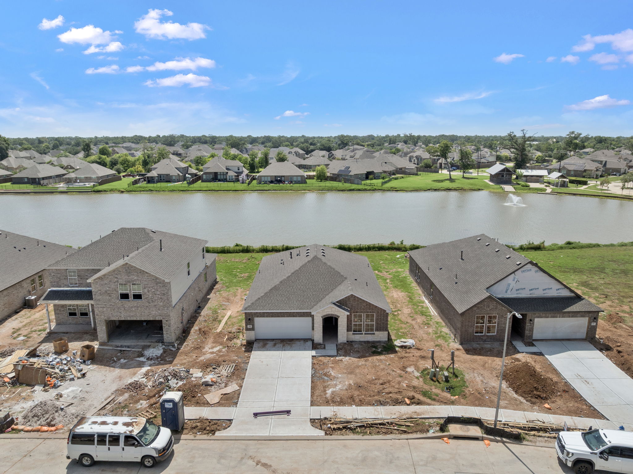 A group of houses next to a body of water.