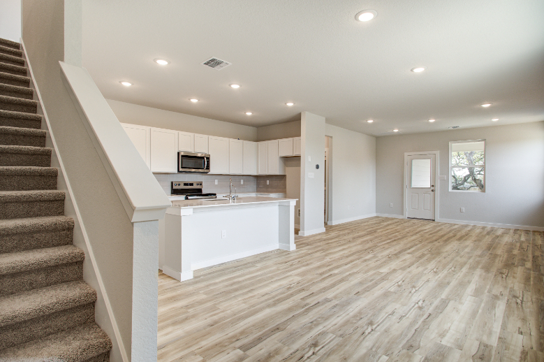 A kitchen with white cabinets.
