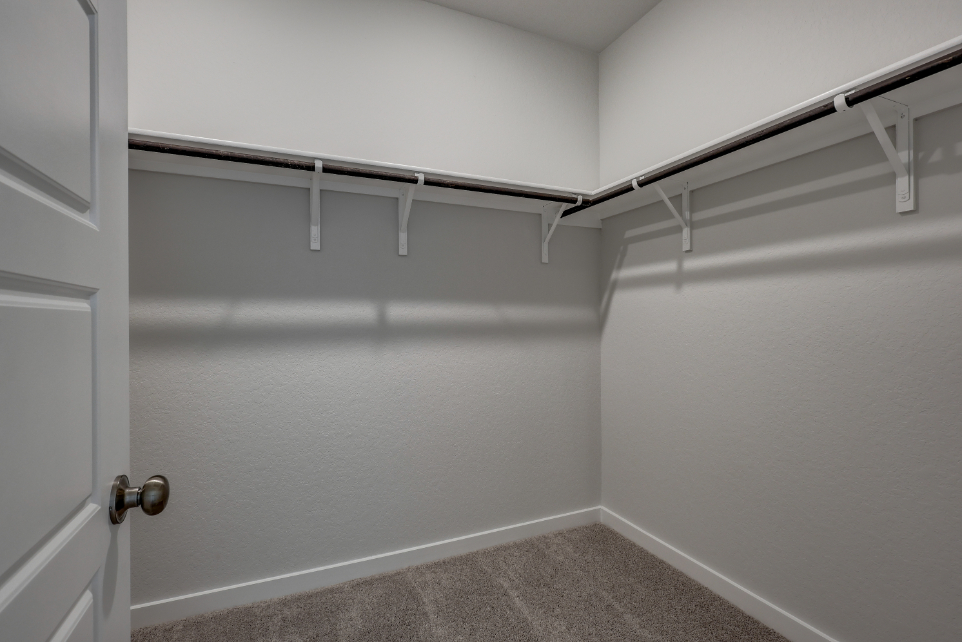 A white wall with a metal railing.