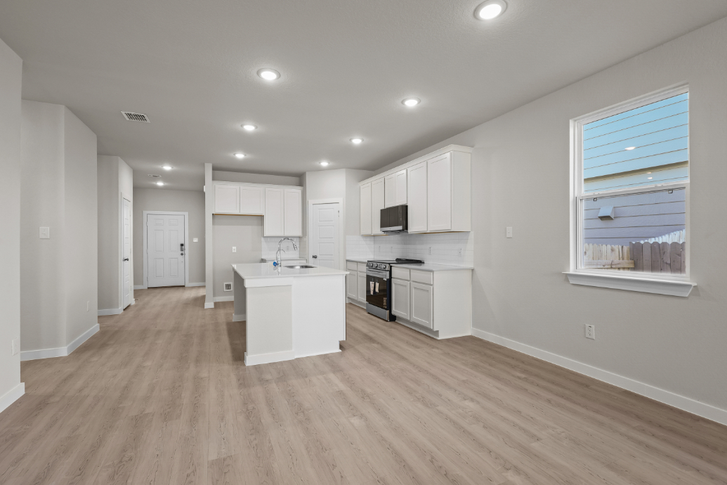 A kitchen with white cabinets.