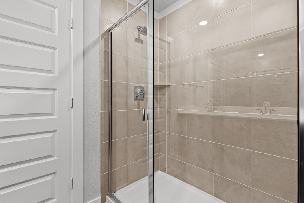 A shower with a glass door.