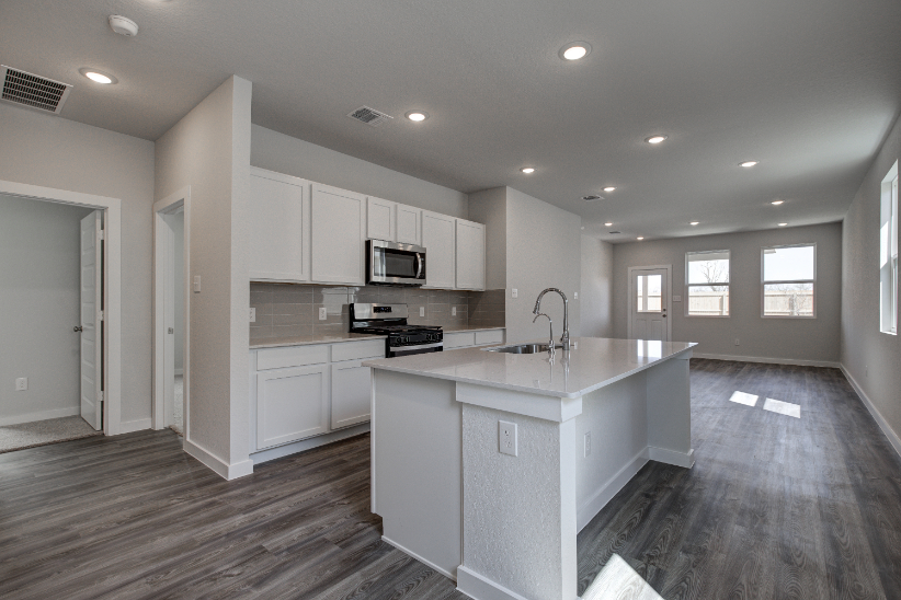 A kitchen with white cabinets.