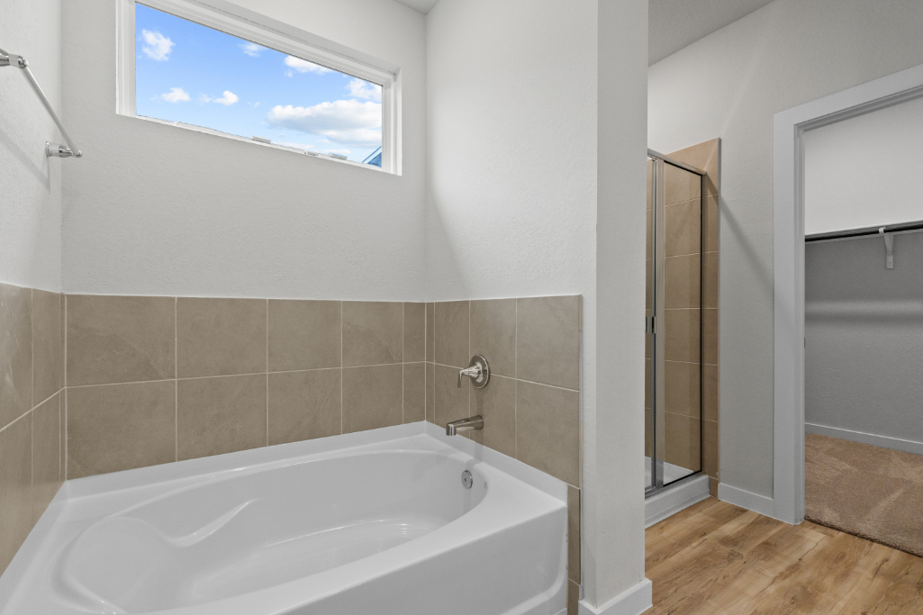 A bathroom with a tub and shower.