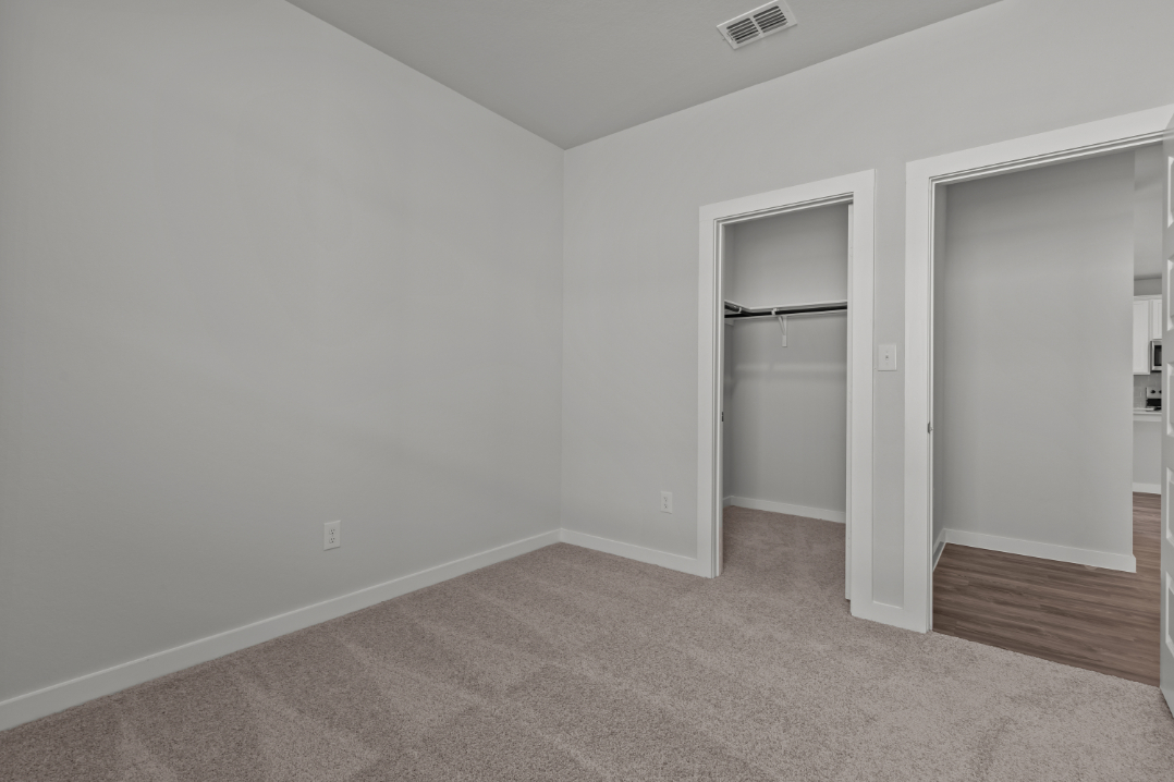 A room with a door and a mirror.