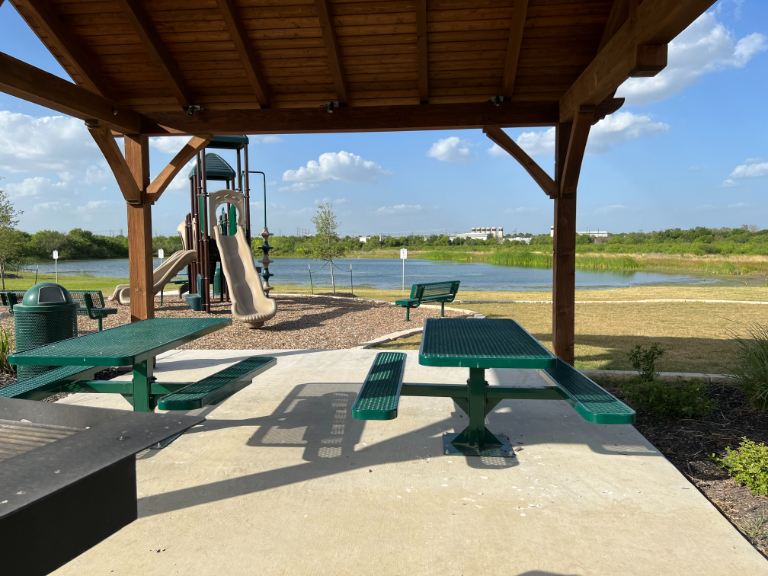 A picnic table and chairs on a deck.