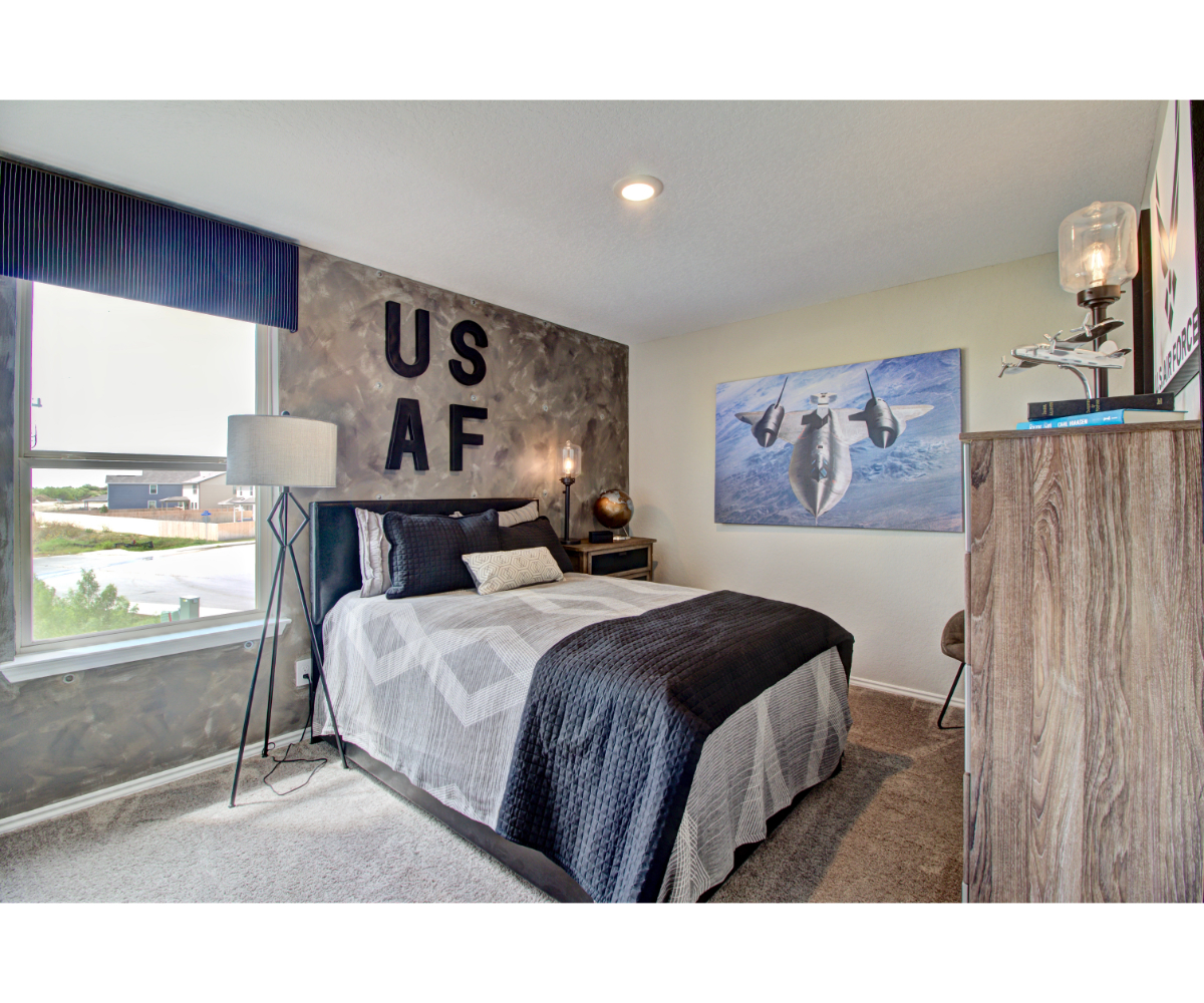 A bedroom with a bed and a poster on the wall.