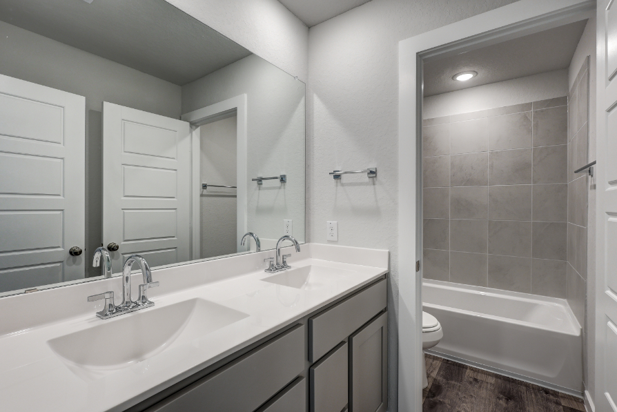 A bathroom with a tub sink and toilet.