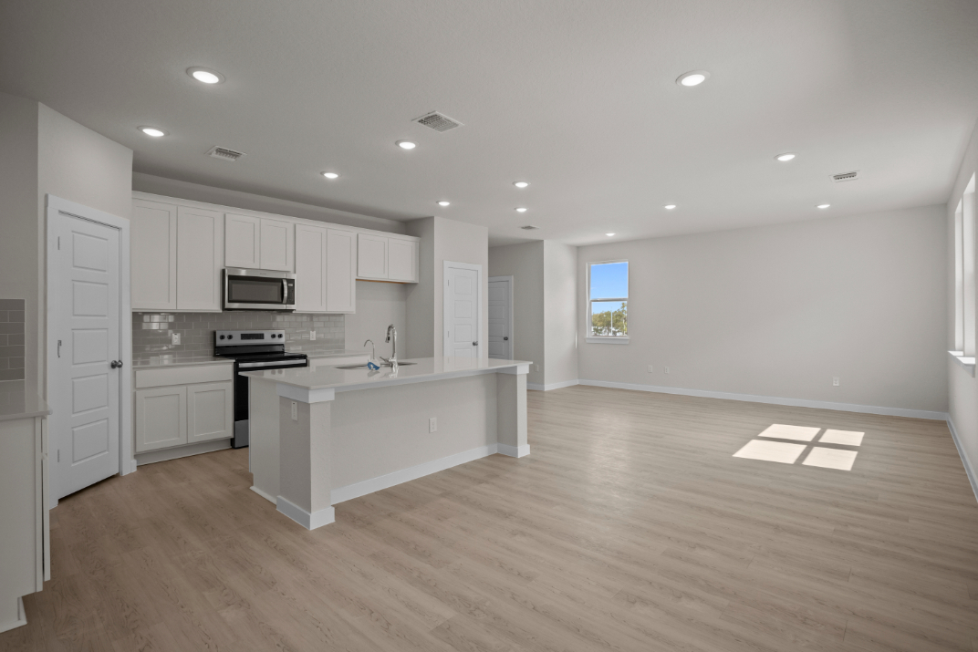 A large kitchen with white cabinets.