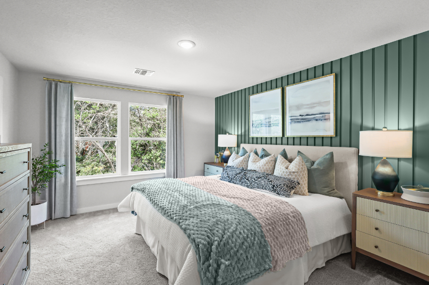 A bedroom with a bed and a window.