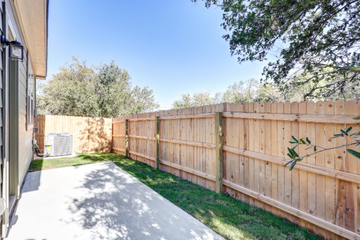 A wooden fence next to a building.
