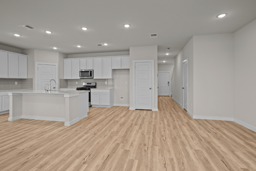 A kitchen with white cabinets.