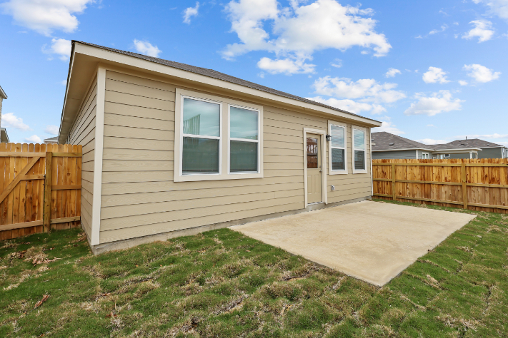 A house with a fence and grass.