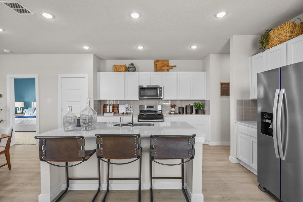 A kitchen with white cabinets.