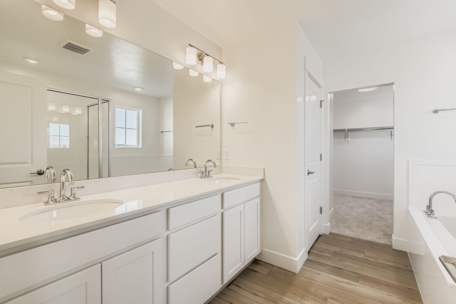 A bathroom with white cabinets.