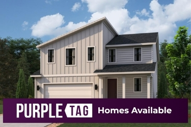 A house with trees in the back.