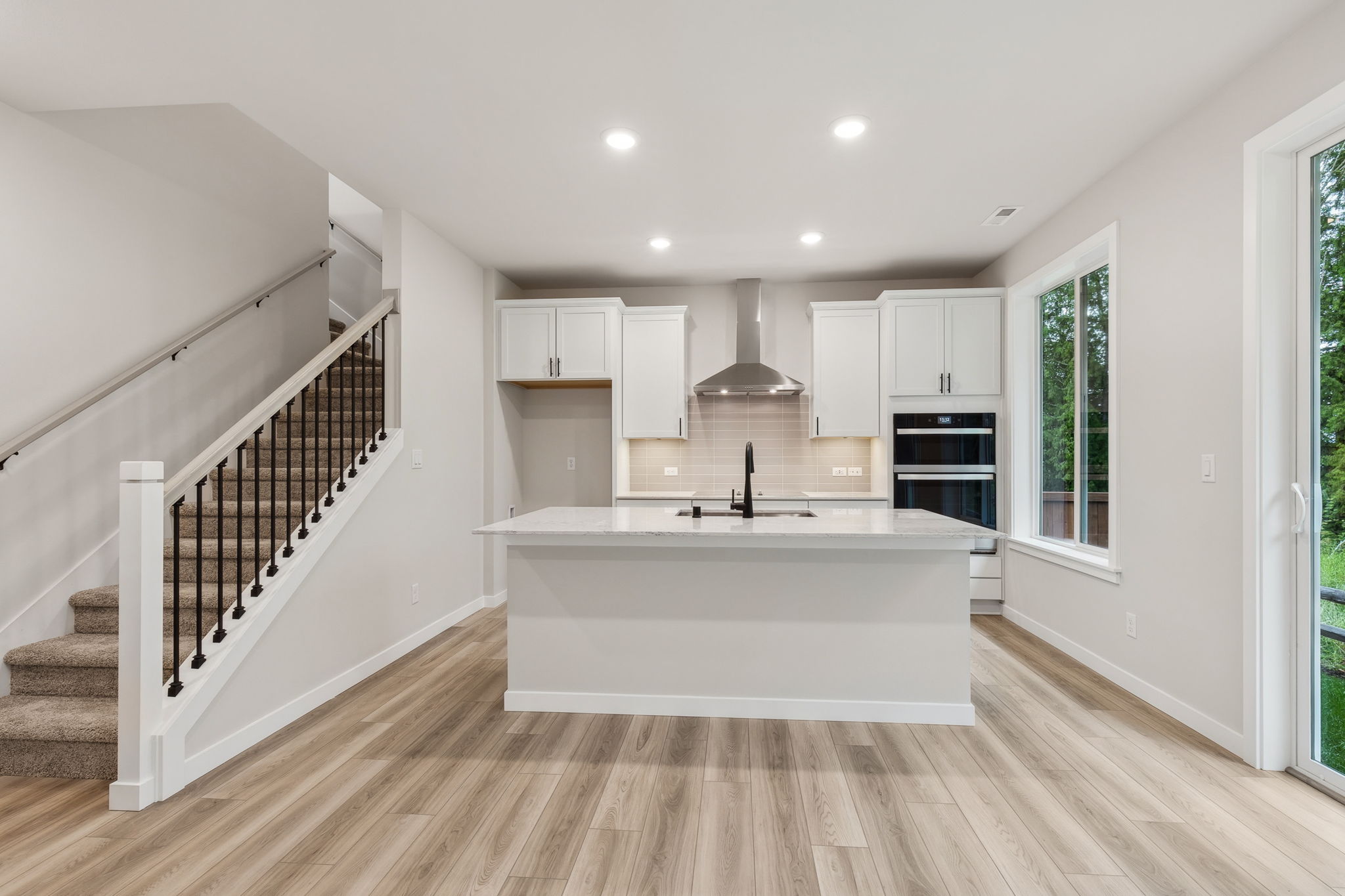 A white kitchen with a white tub.