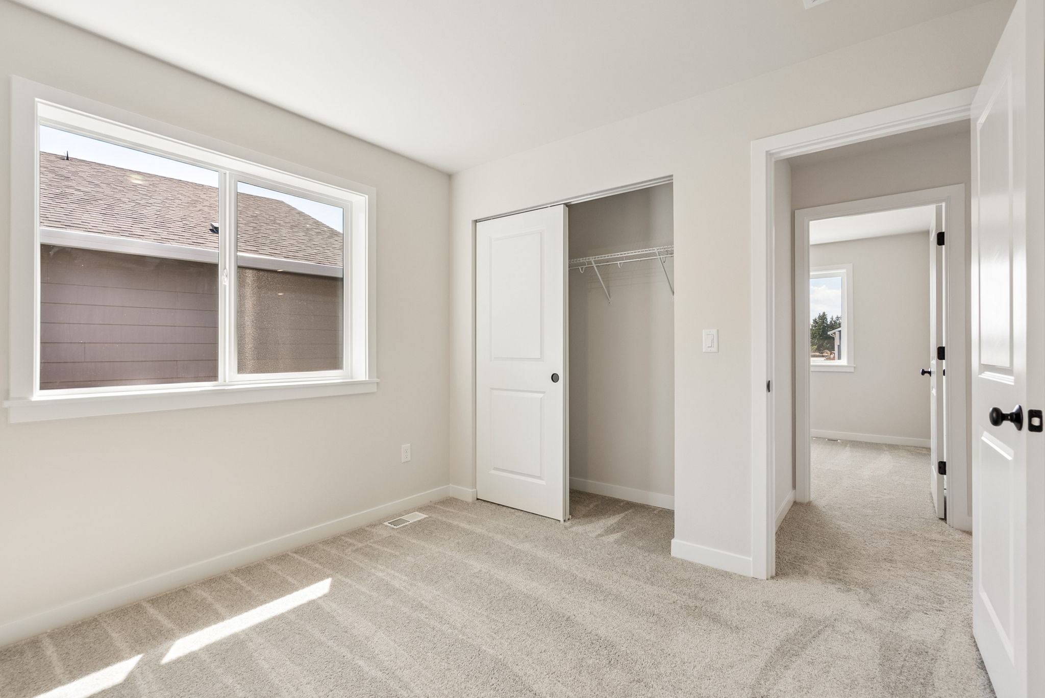 A room with white walls and a window.