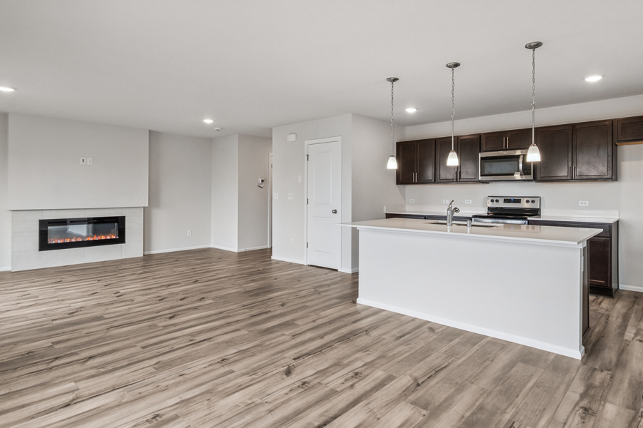 A kitchen with a wood floor.