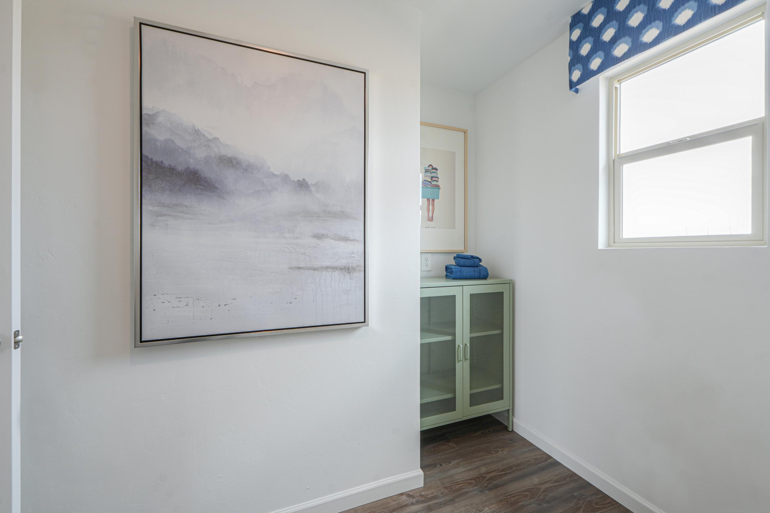 A room with a picture on the wall.