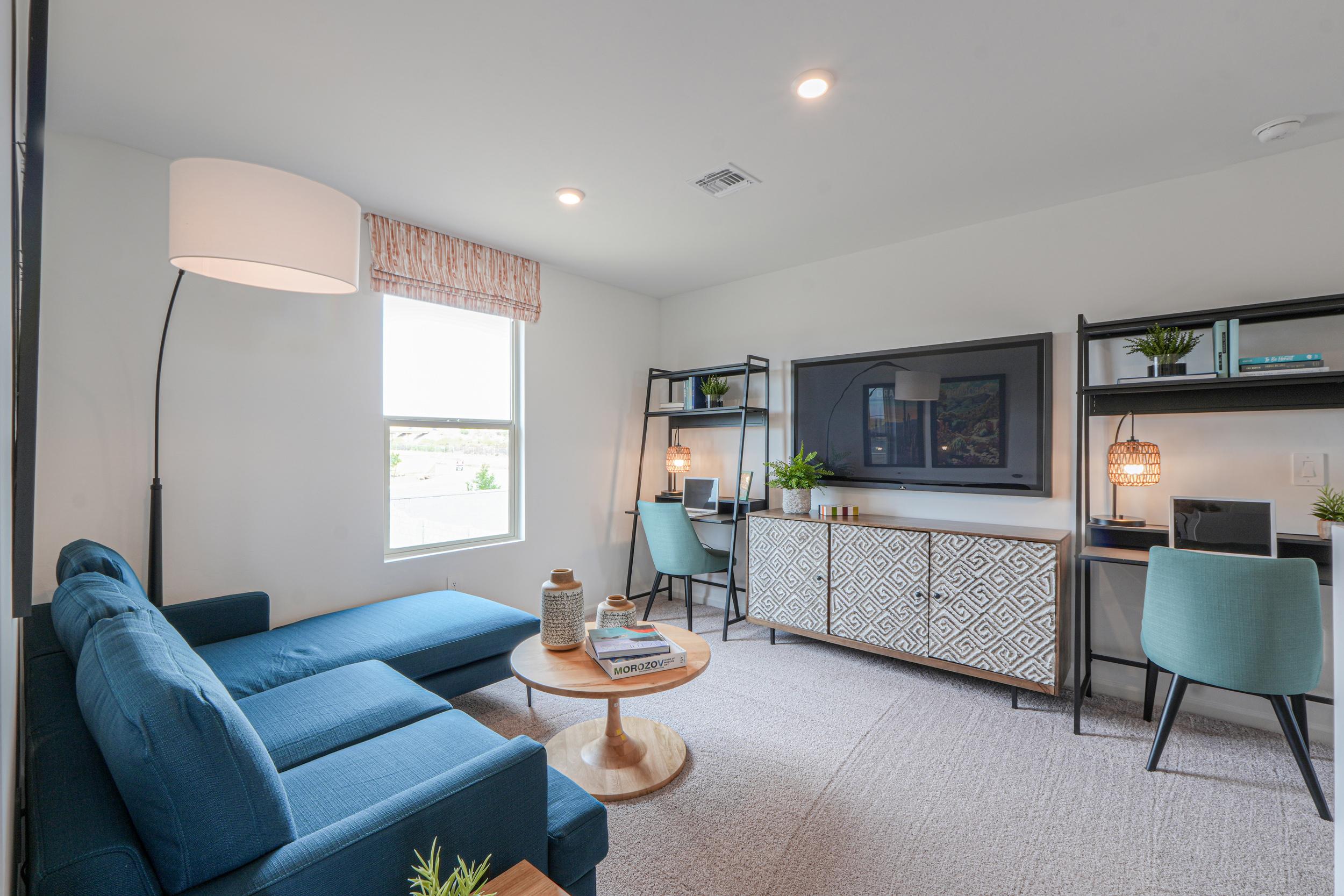 A living room with blue couches.