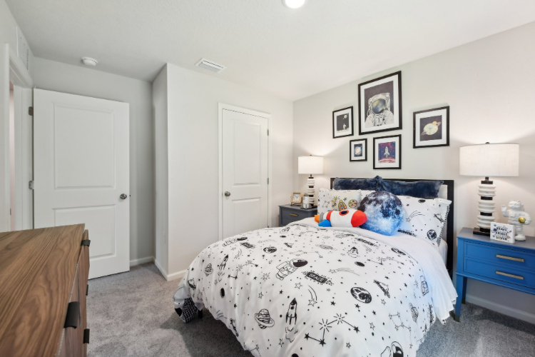 A bedroom with a bed and a dresser.