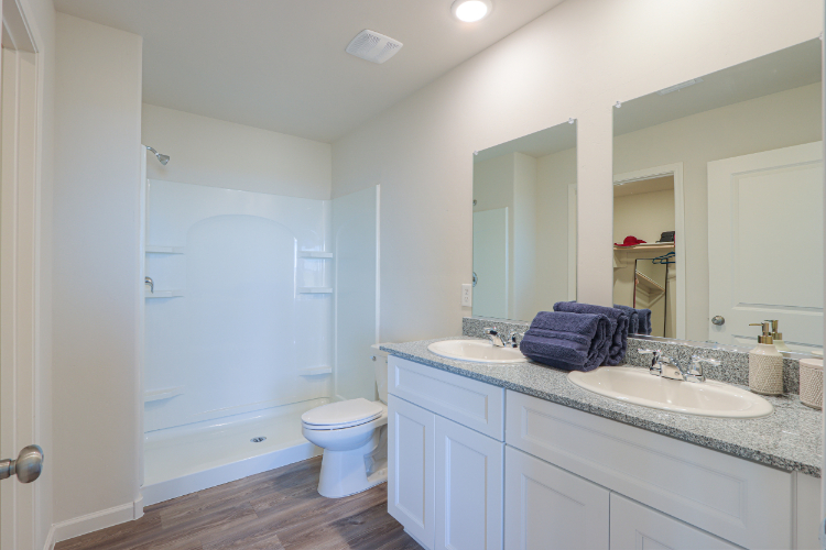 A bathroom with a tub sink and toilet.