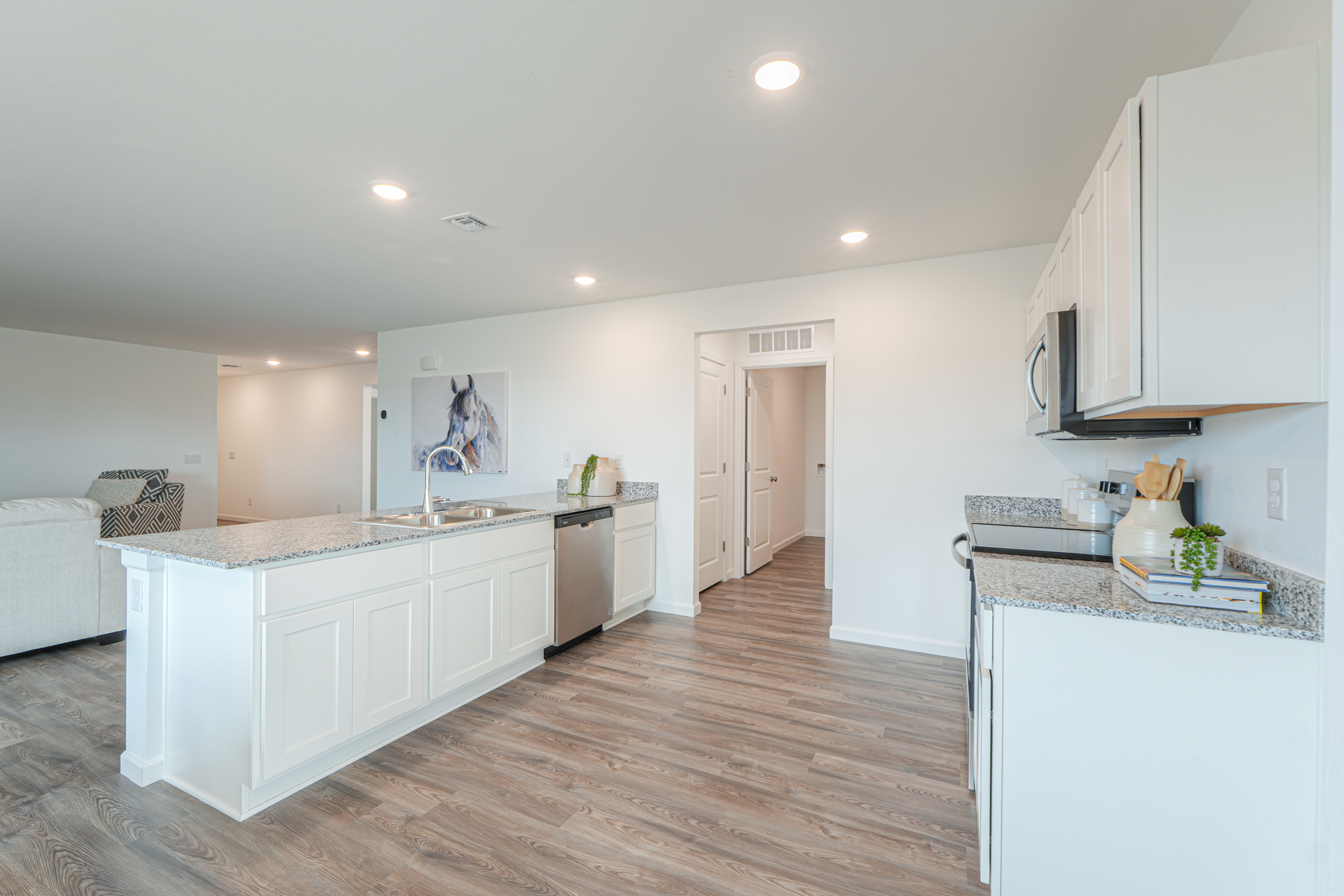 A kitchen with white cabinets.
