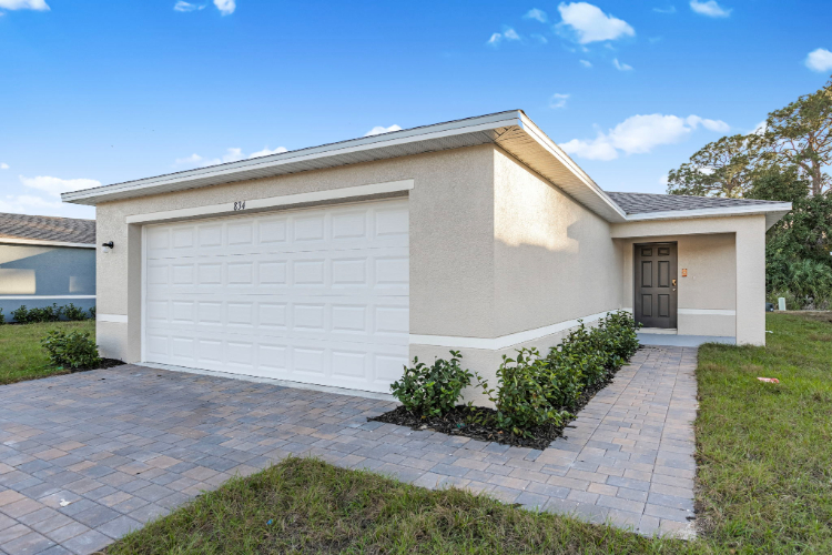 A white house with a driveway.