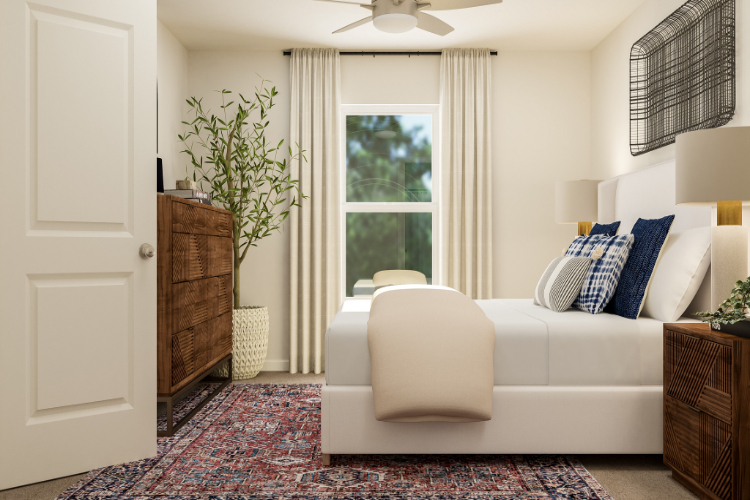 A living room with a white couch and a white chair.