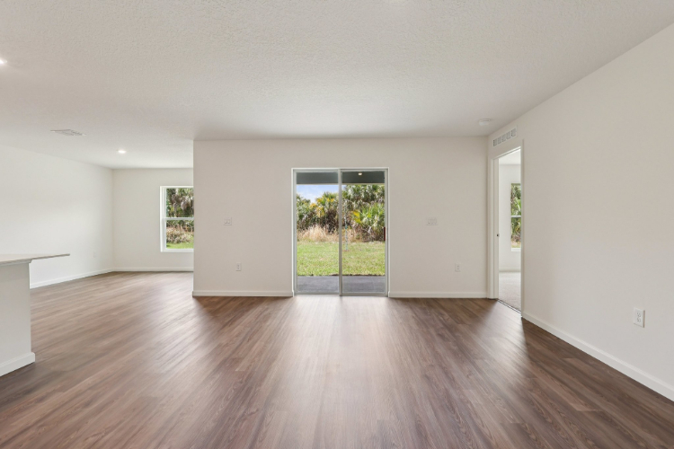 A room with a wood floor and a wood floor with a window.