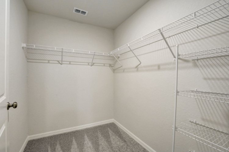 A white room with a metal rack.