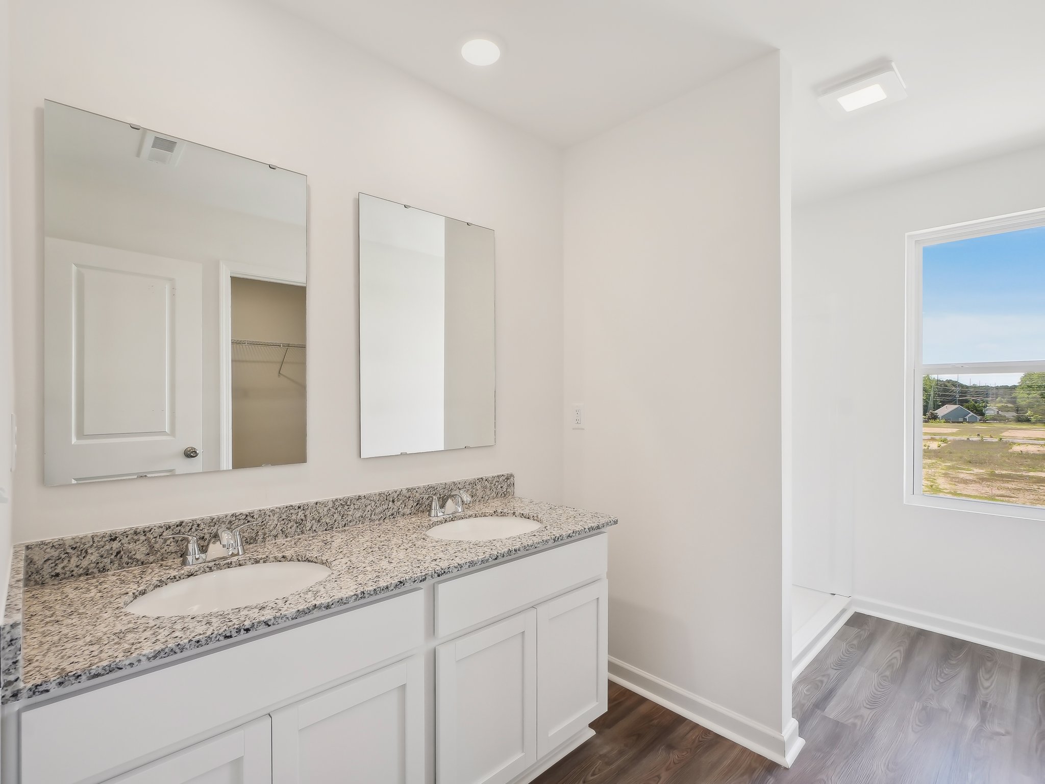 A bathroom with a large mirror.