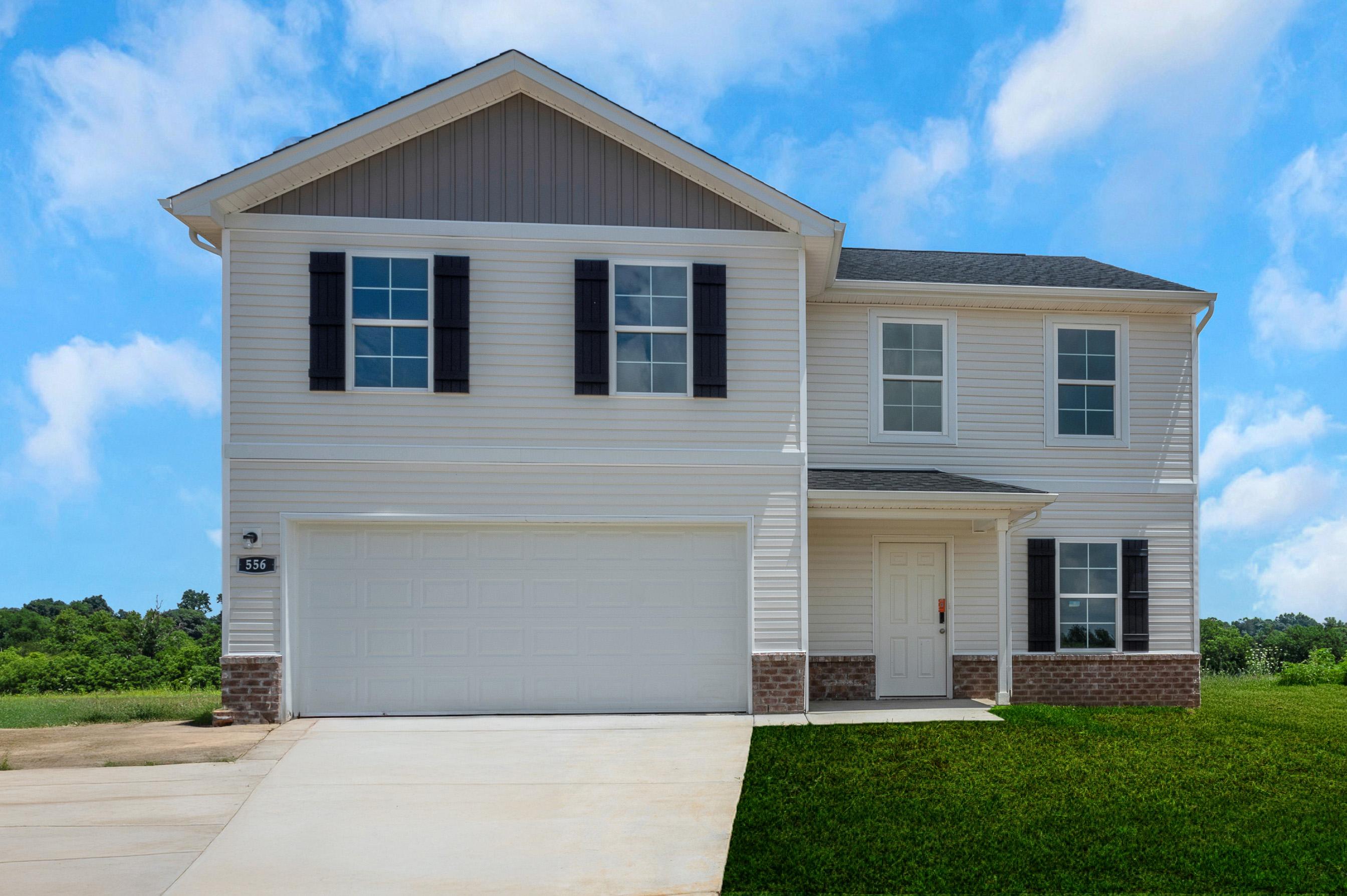 A white house with black shutters.