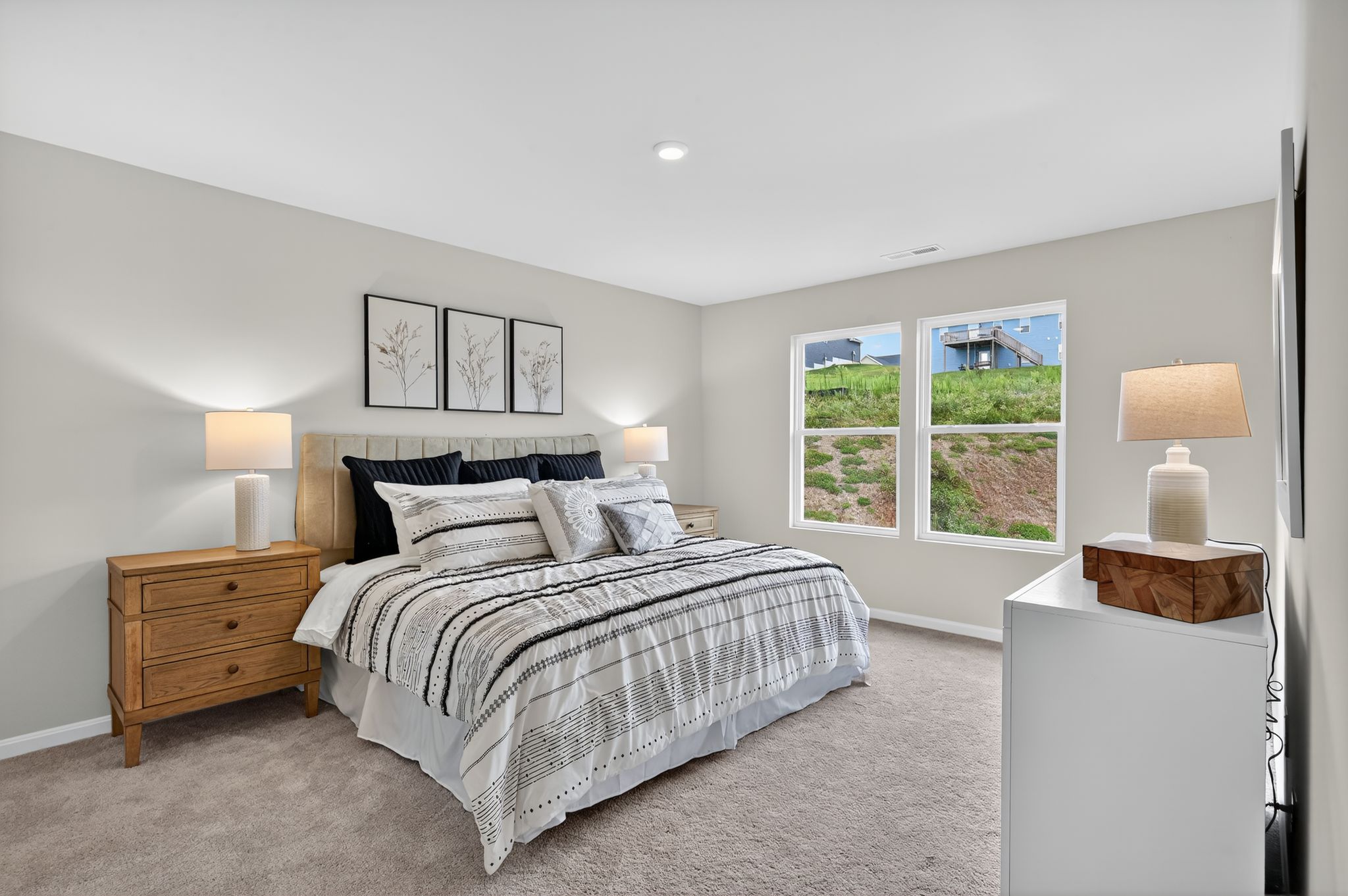 A bedroom with a bed and lamps.