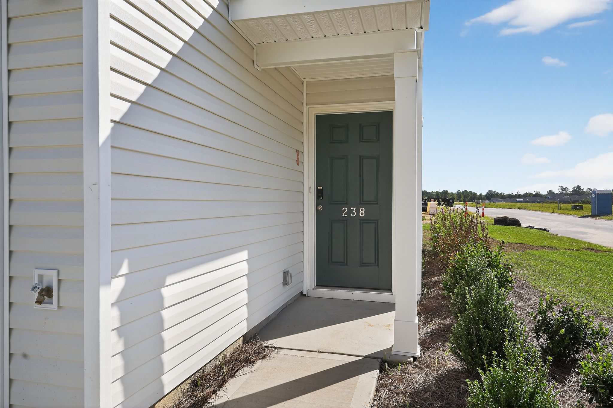 A white house with a green door.