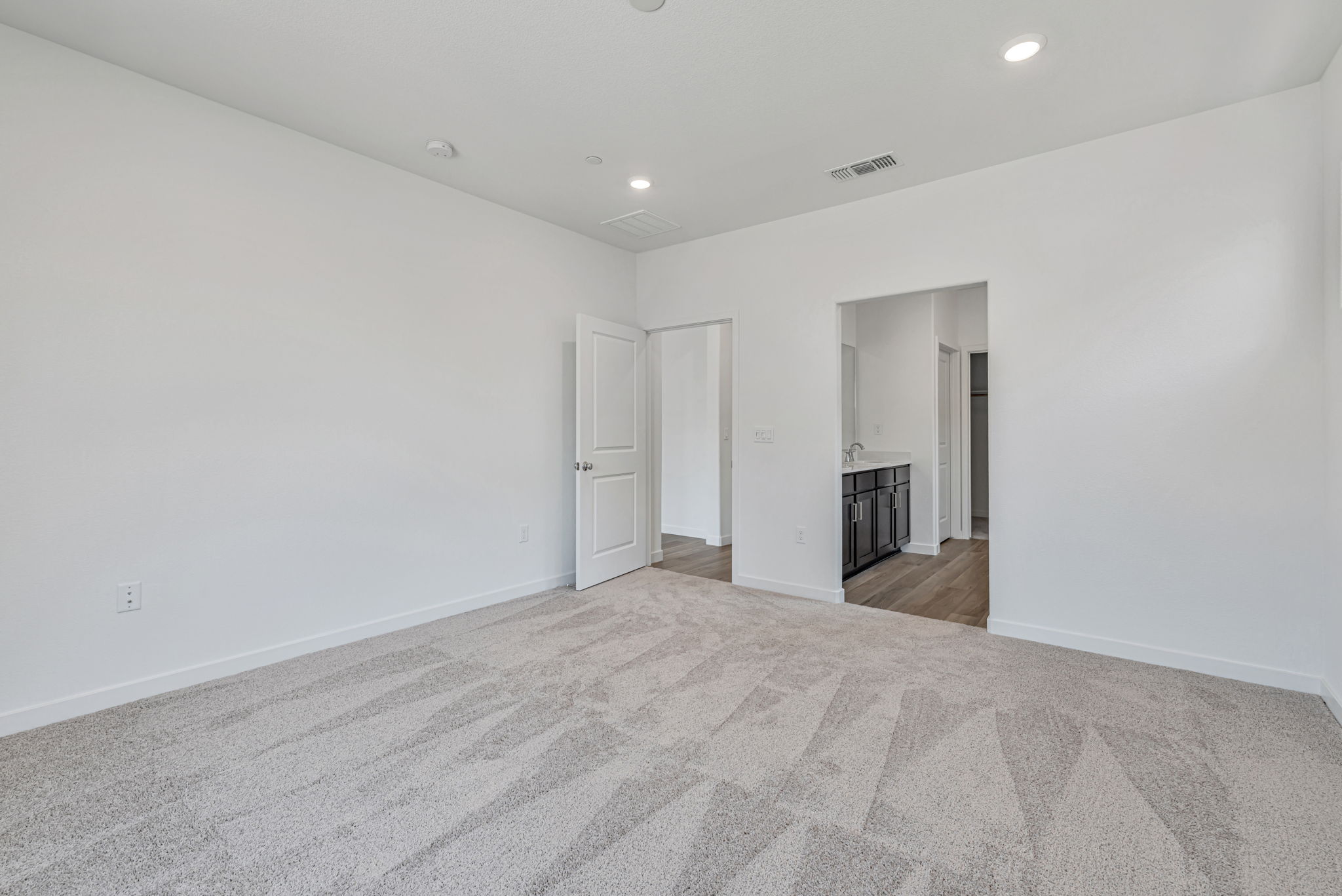 A long hallway with white walls.